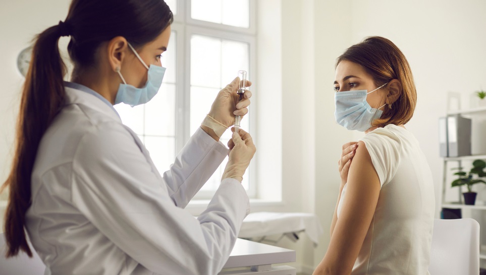 woman getting a flu shot in a clinic