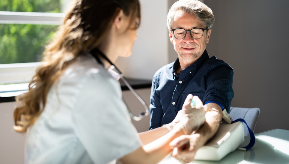 a doctor conducting a blood test in her patient