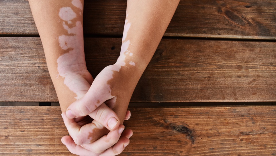 man holding hands in a wooden table