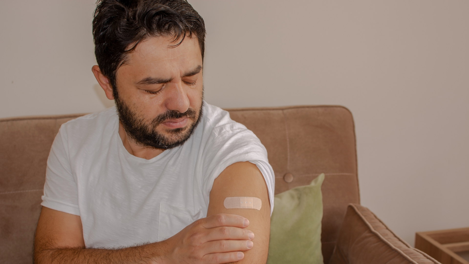man in pain after vaccination