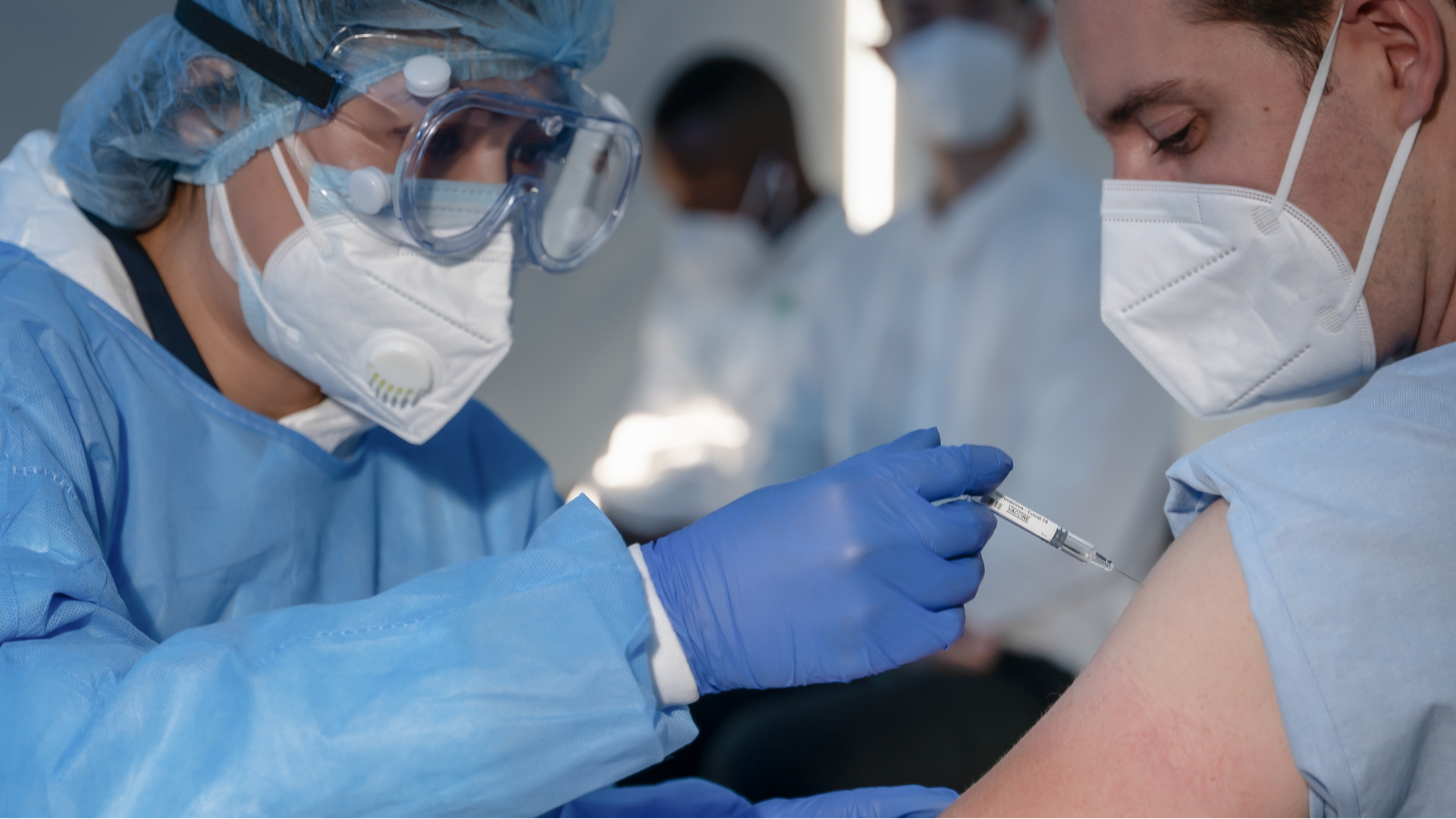 hand of medical staff injecting coronavirus covid 19 vaccine