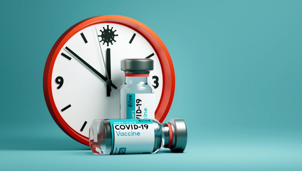 clock and covid vaccine bottle