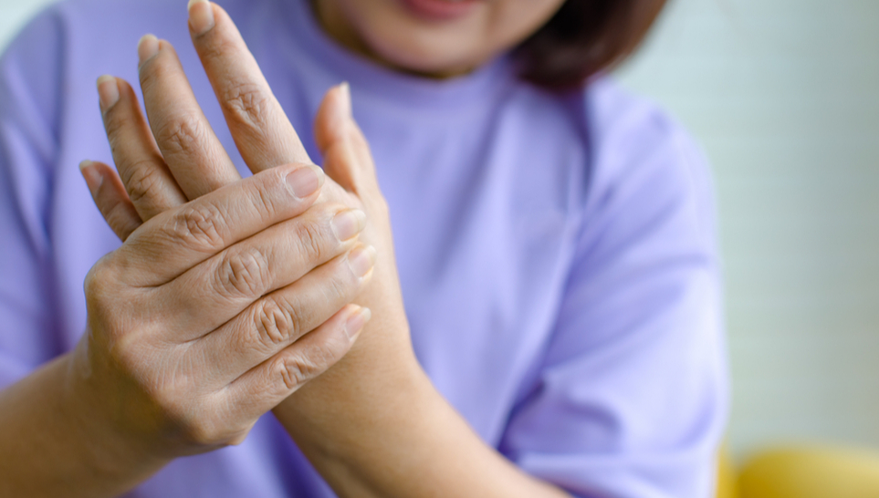 woman experiencing numbness of her hand after receiving a vaccine