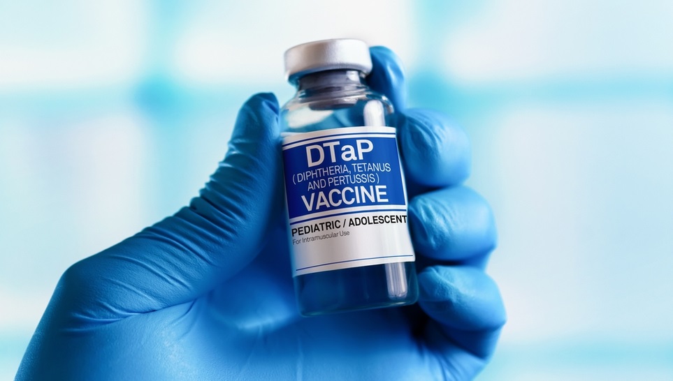 hand holding a dtap vaccine