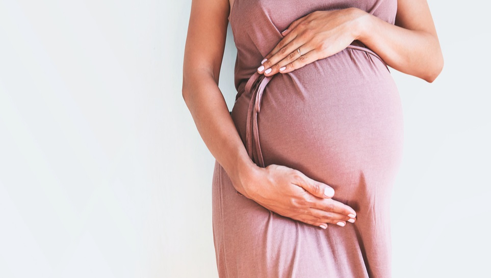 pregnant woman in a red pale dress