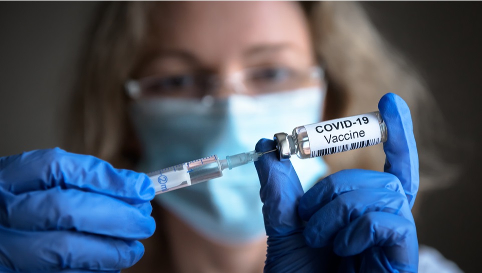 woman getting a covid vaccine in a bottle