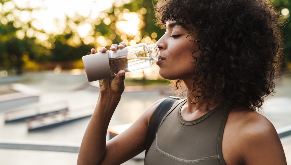 woman drinking water in the park