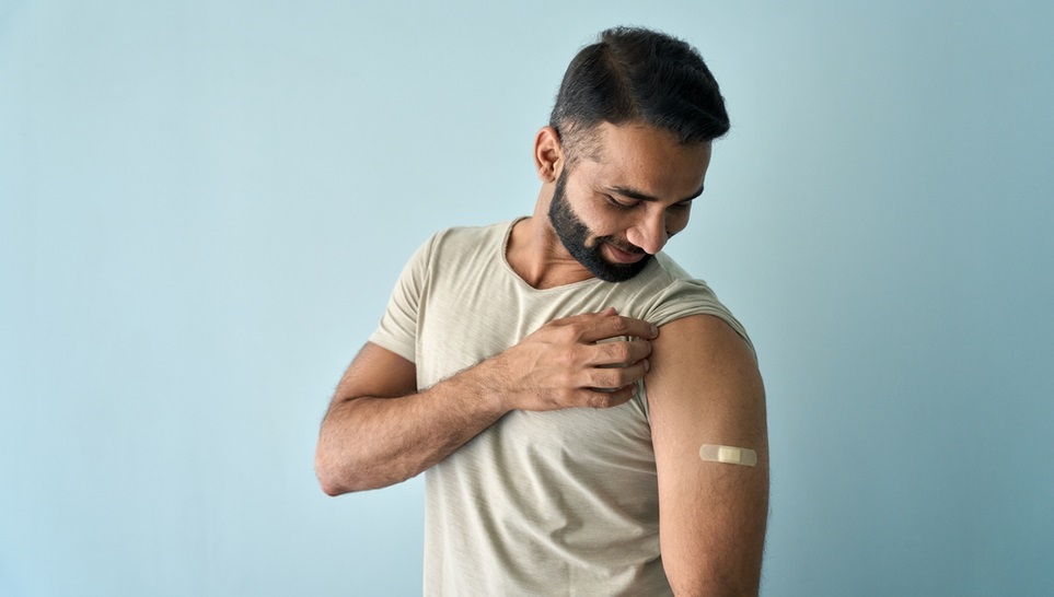 man checking his shoulder after he was vaccinated