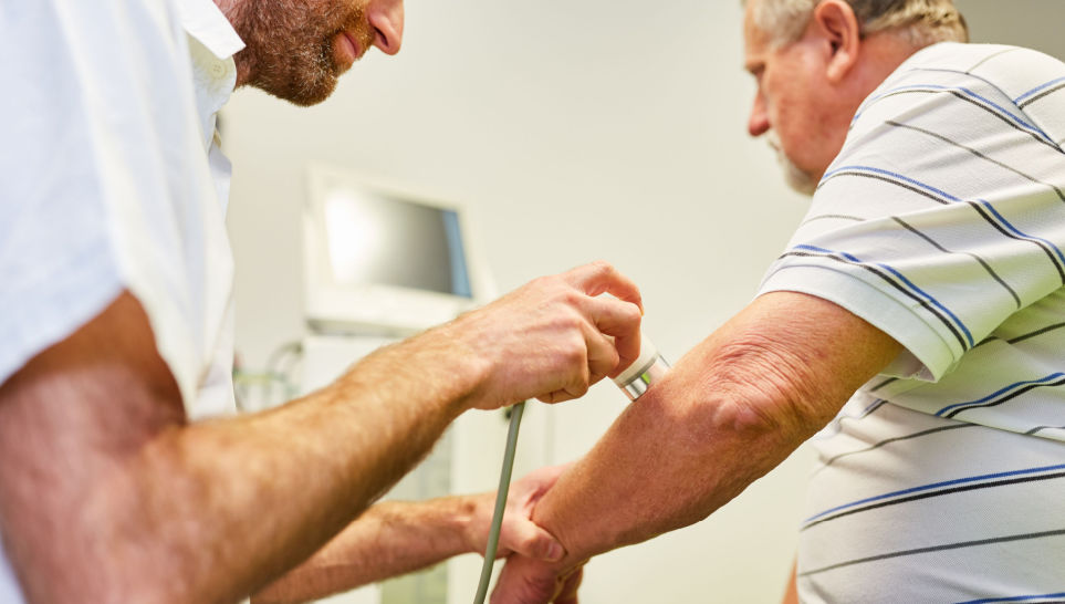 doctor makes theraphy on the elbow of patient because of muscle pain