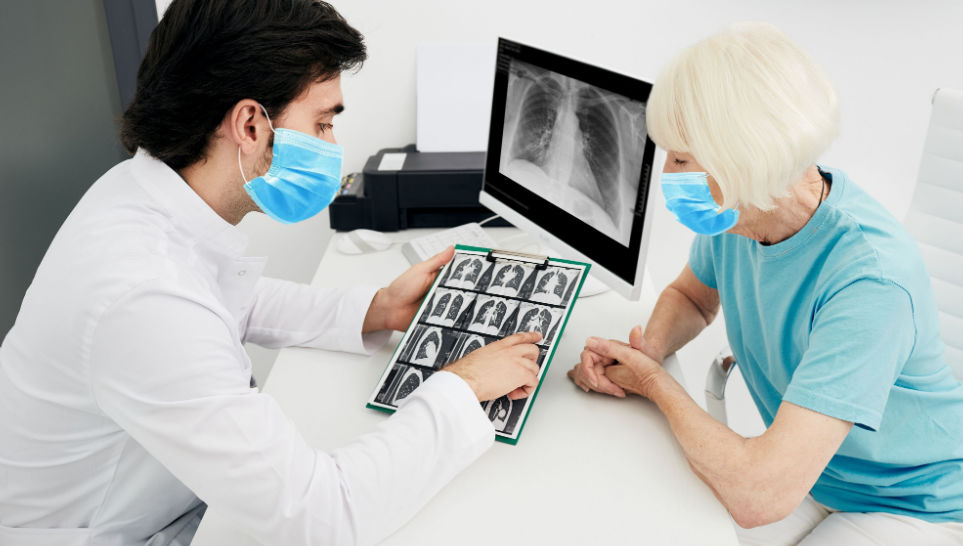 doctor showing x ray to patient with tuberculosis