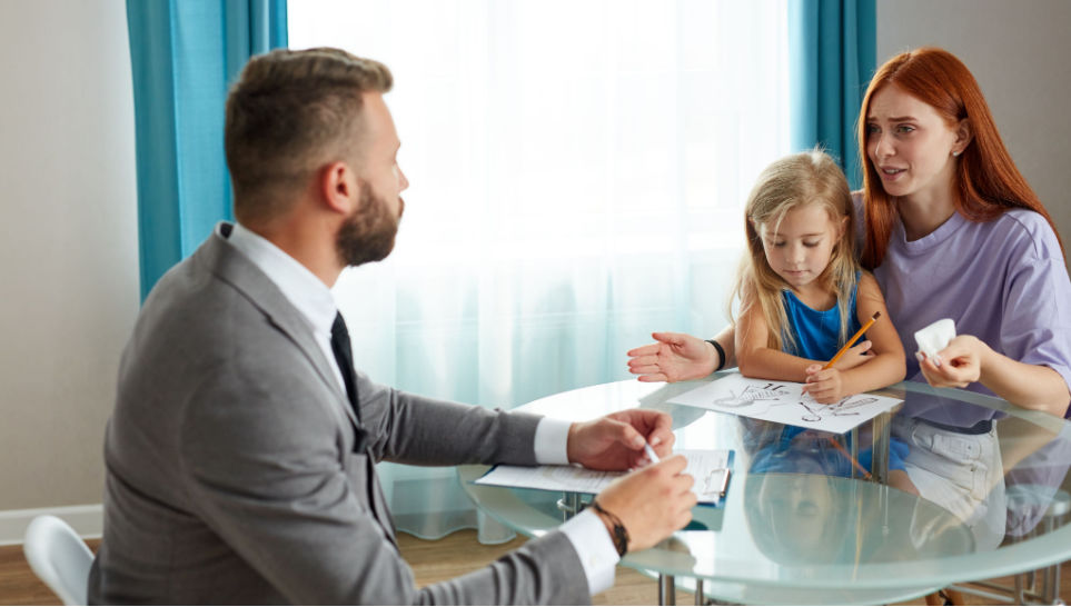 mother with her female child consulting a lawyer about compensation