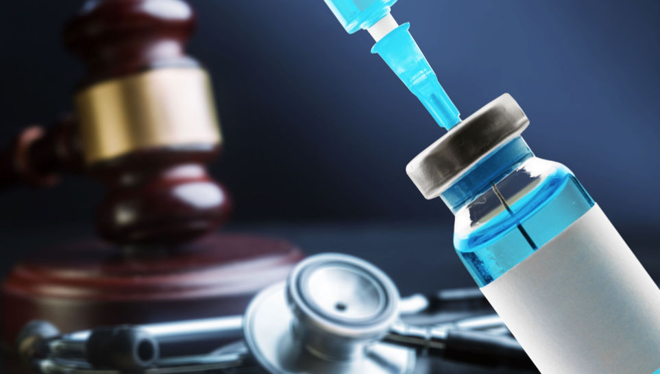vial of vaccine and syringe with gavel background