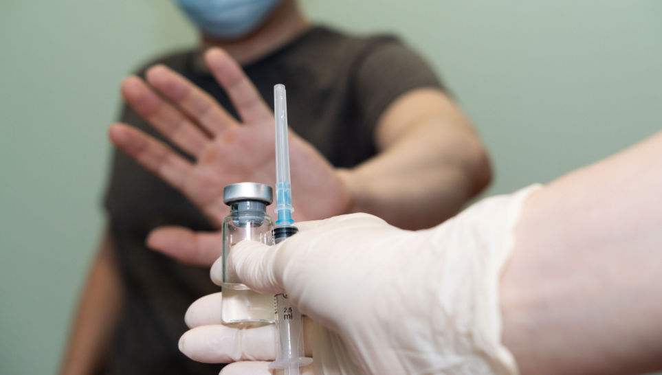 man declining flu vaccine