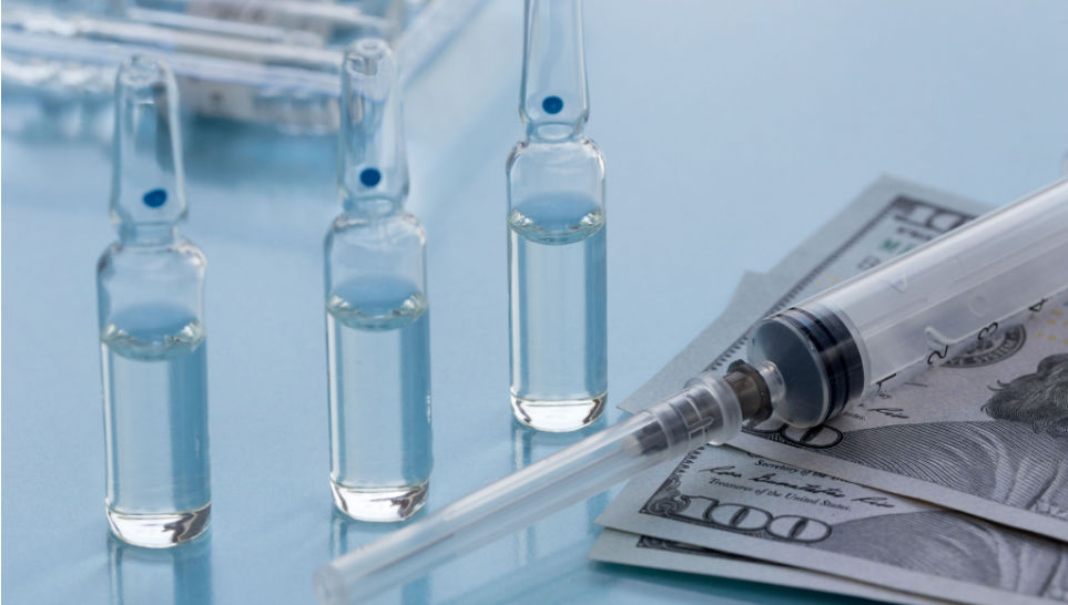 syringe vials and dollar banknotes