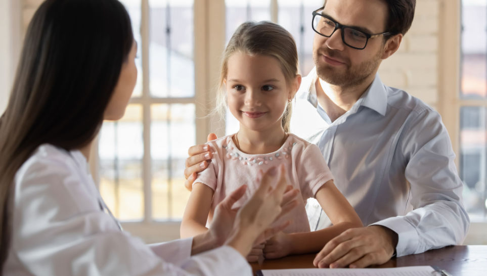 father consulting doctor about prevnar vaccine for her daughter