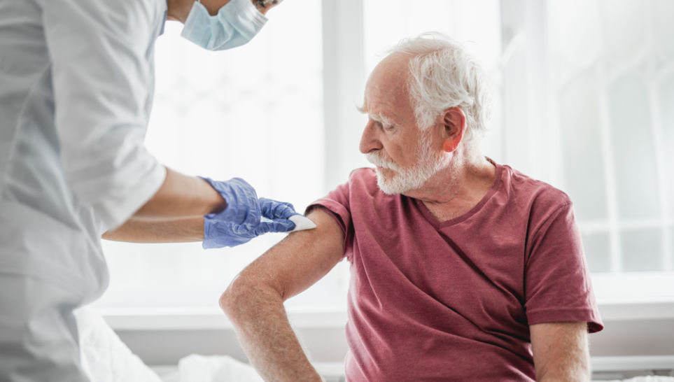 elder man receiving hepatitis b vaccine