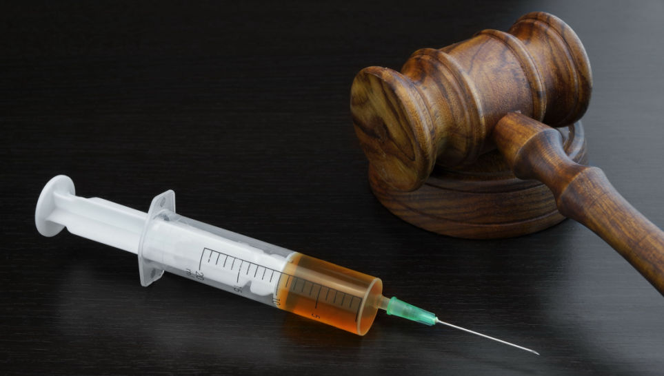 judge gavel and medical syringe with vaccine on black background