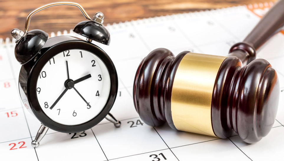 judges gavel with clock and calendar on table