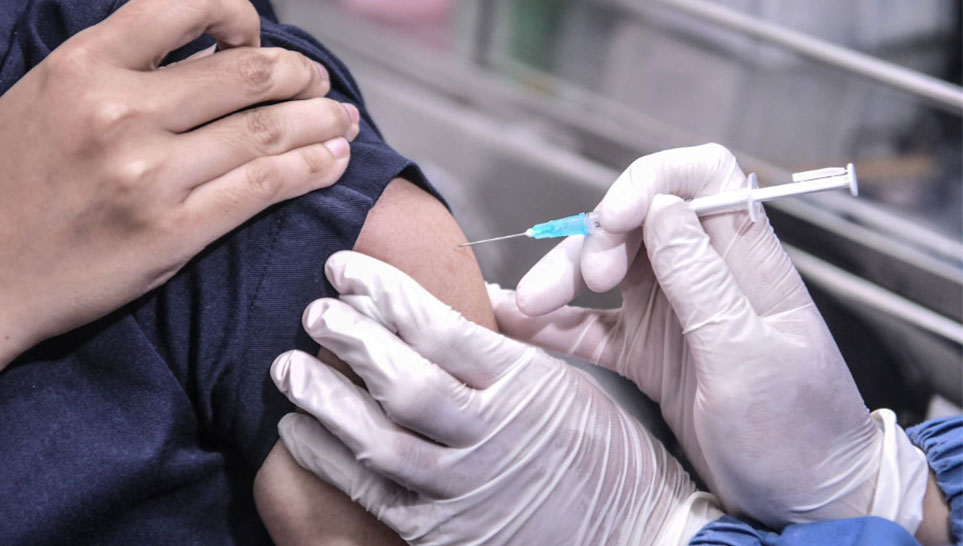 man getting vaccinated by hospital nurse