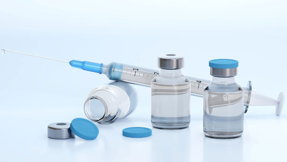 syringe and small glass bottles with vaccines