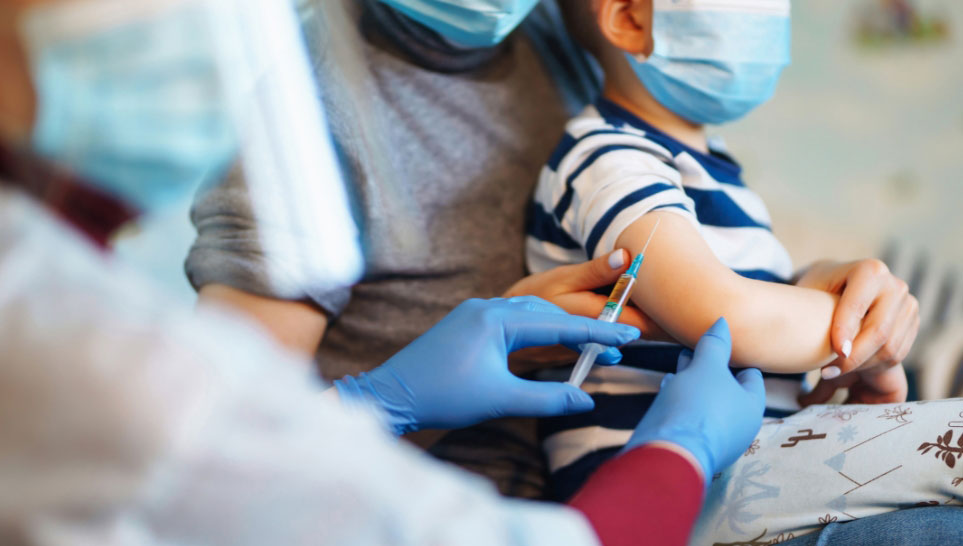 kid getting vaccinated by doctor