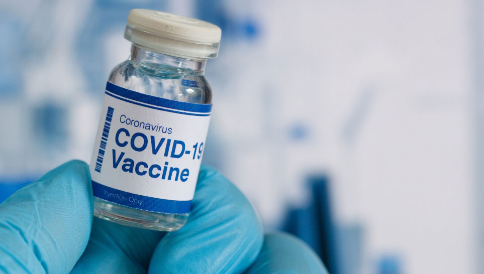 nurse holding small bottle with covid 19 vaccine