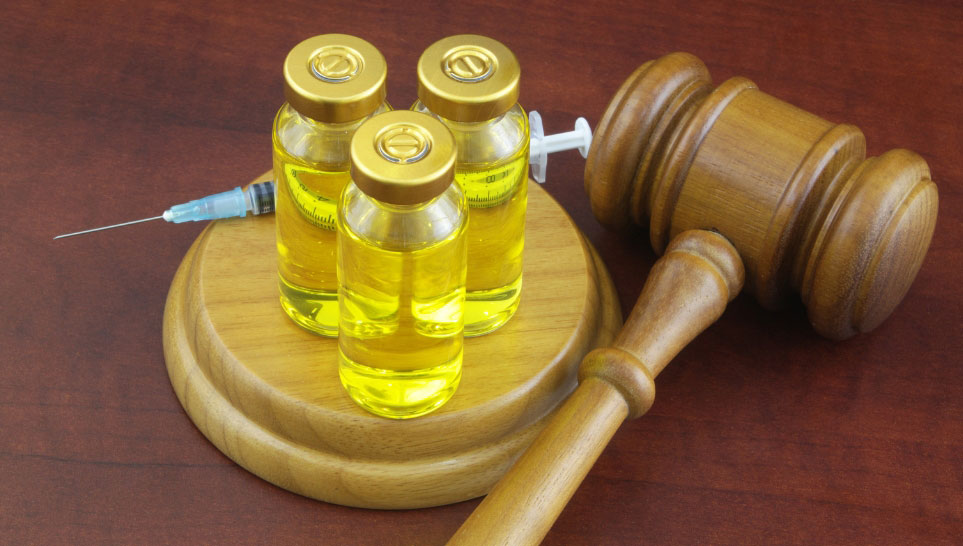 wooden gavel bottle with vaccine and syringe