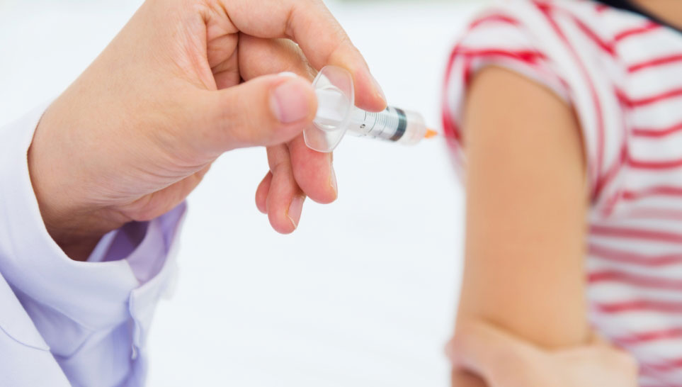 doctor giving polio vaccine to a children