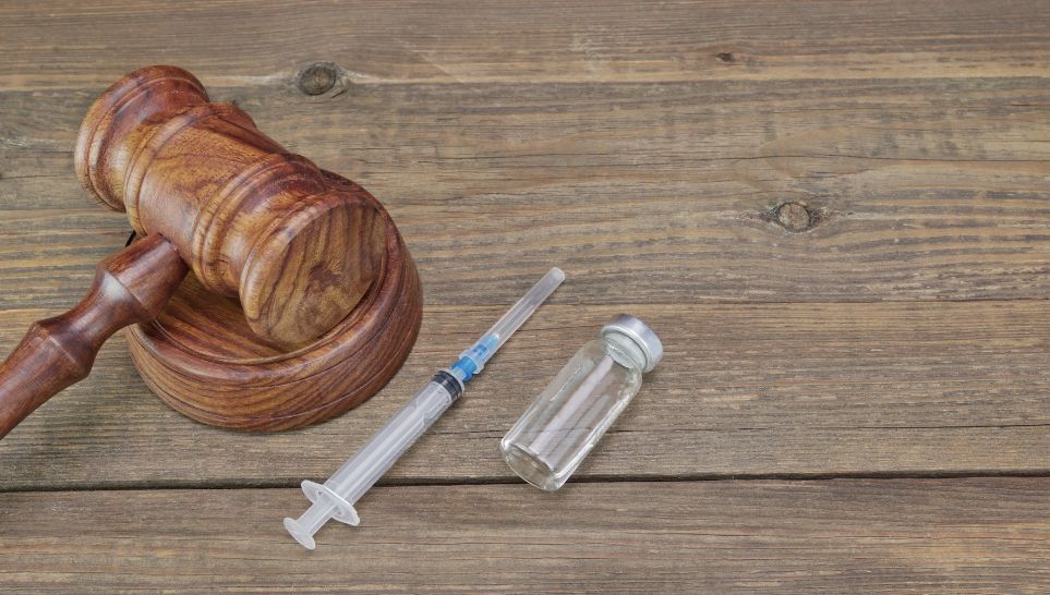 judge gavel and medical drugs on wooden background