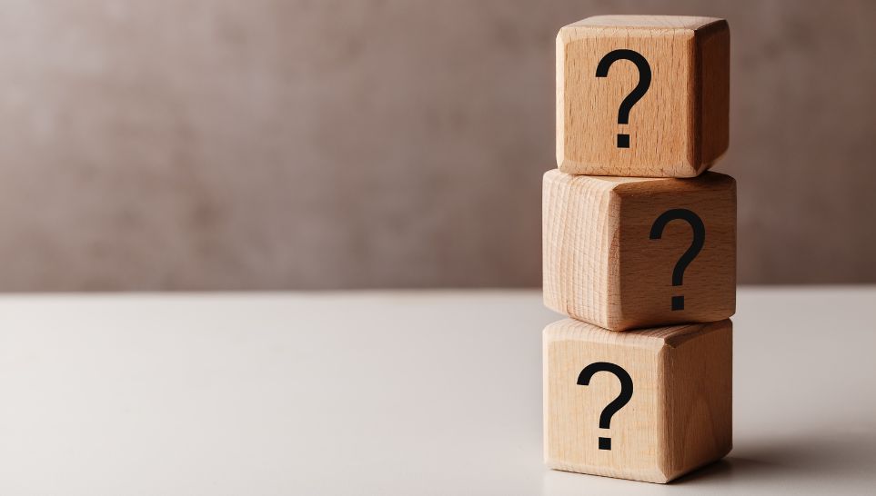 stack of wooden cubes with question marks