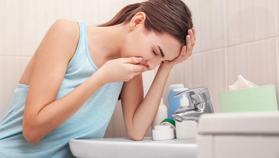woman vomiting on sink side effect of hepatitis b vaccine