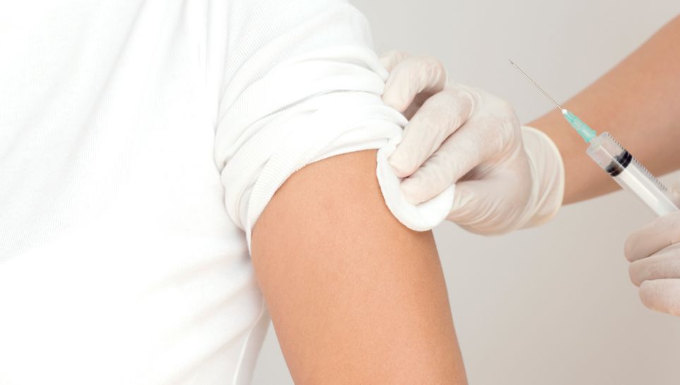 young male patient receiving flu vaccine